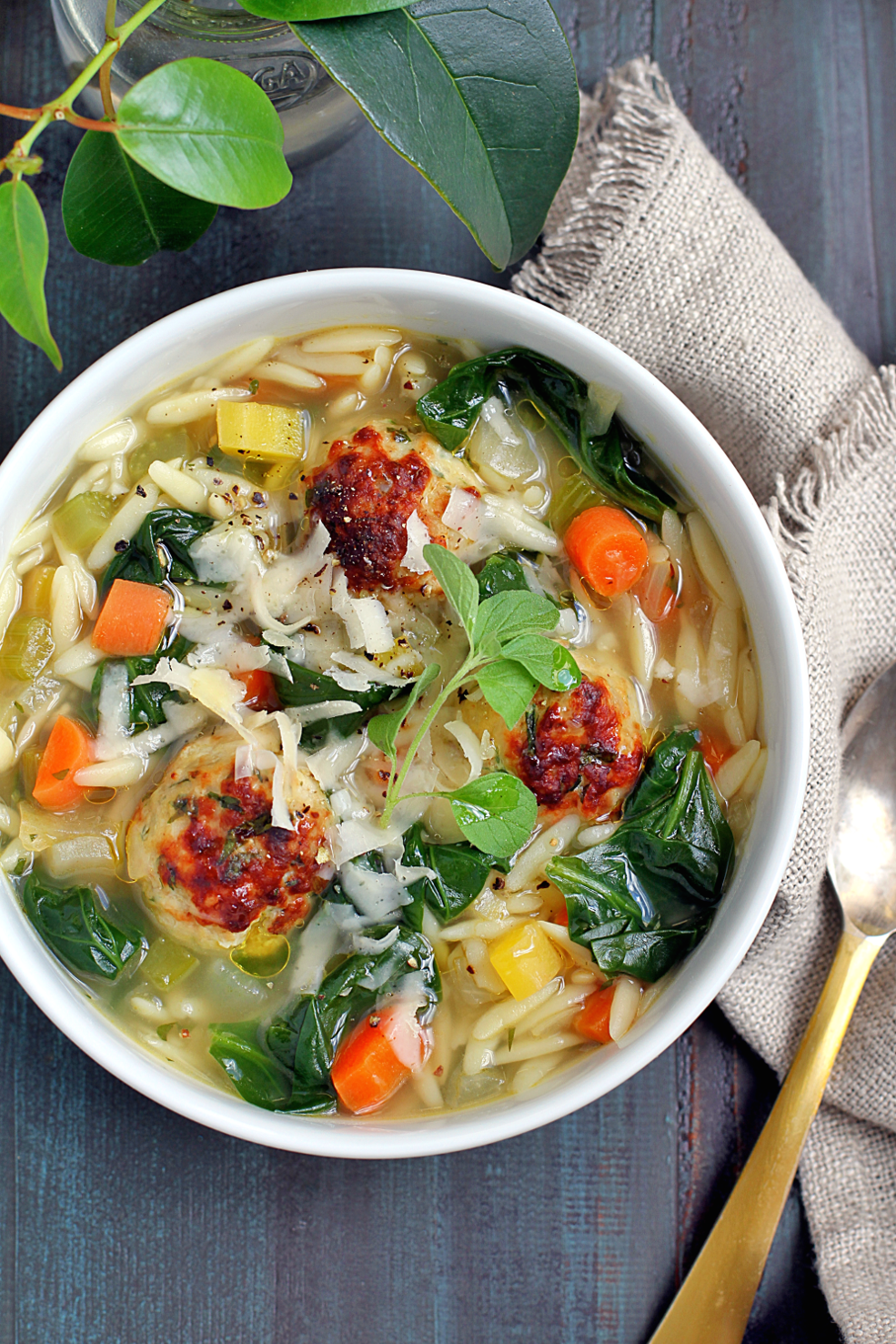 Close-up image of Italian wedding soup with chicken meatballs.