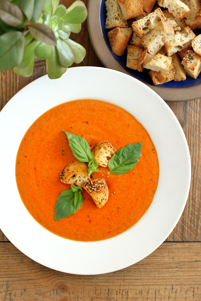 Close-up image of creamy tomato basil soup.