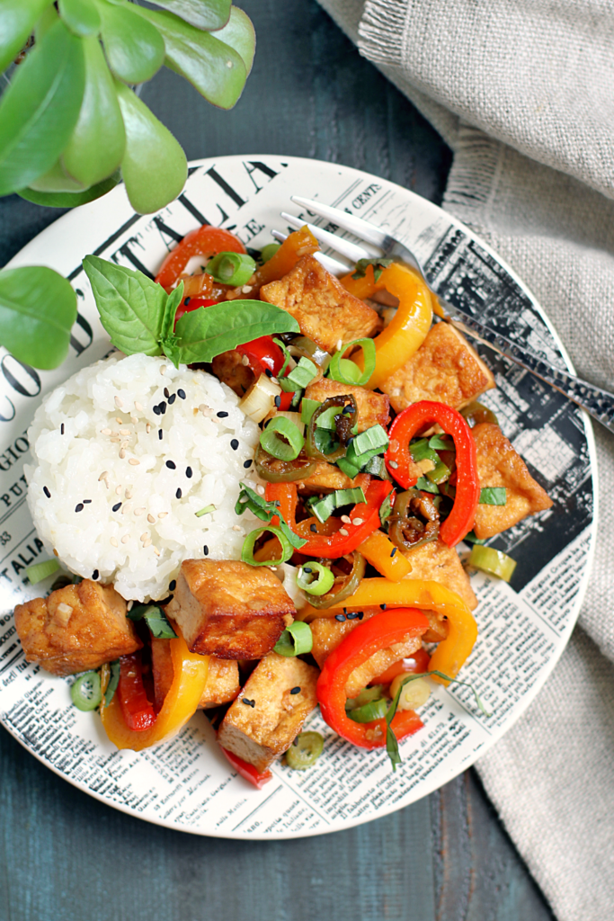 Close-up image of spicy tofu stir-fry with coconut sticky rice.