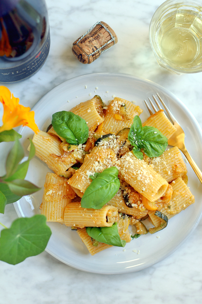 Close-up image of Wilson Creek Brut Sparkling Wine with summer squash and basil pasta from the top.