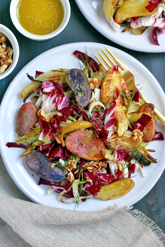 Close-up image of roasted fennel and potato salad with bagna càuda dressing.