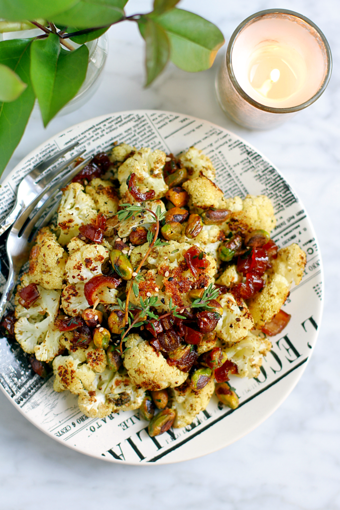 Close-up image of za'atar roasted cauliflower with dates and pistachios.