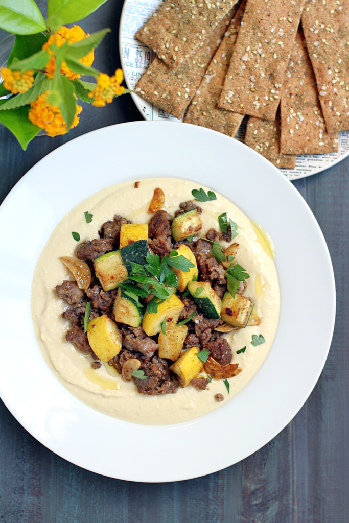 Image of hummus with spiced lamb and summer squash.
