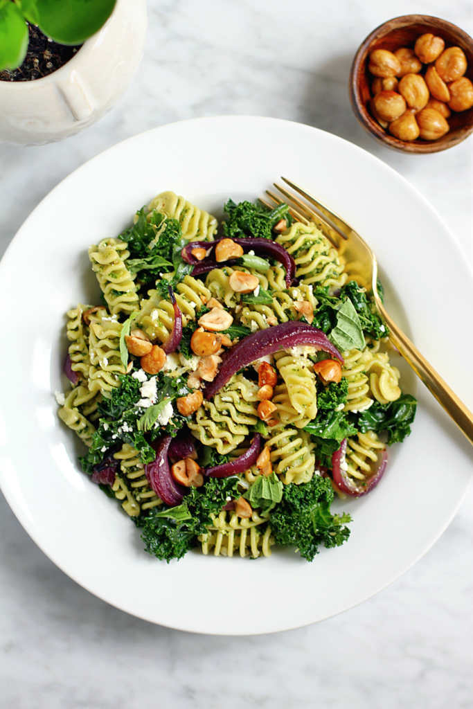 Close-up image of pasta with kale and hazelnut pesto.