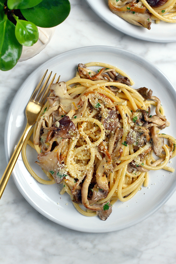 Close-up image of creamy pasta with mushrooms.