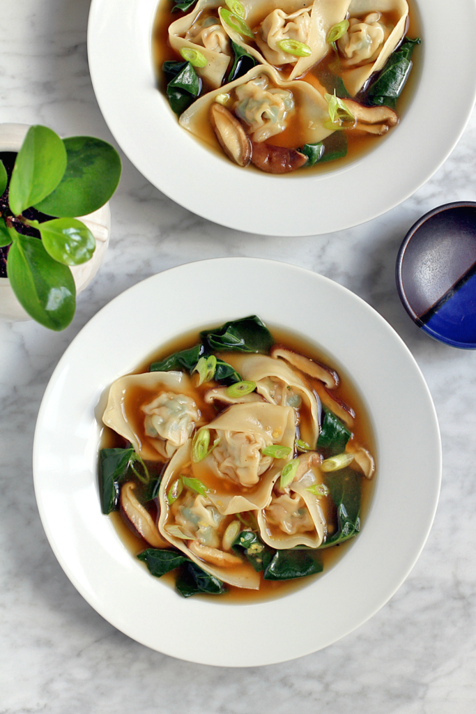 Image of pork wonton soup with chard and shiitake mushrooms.