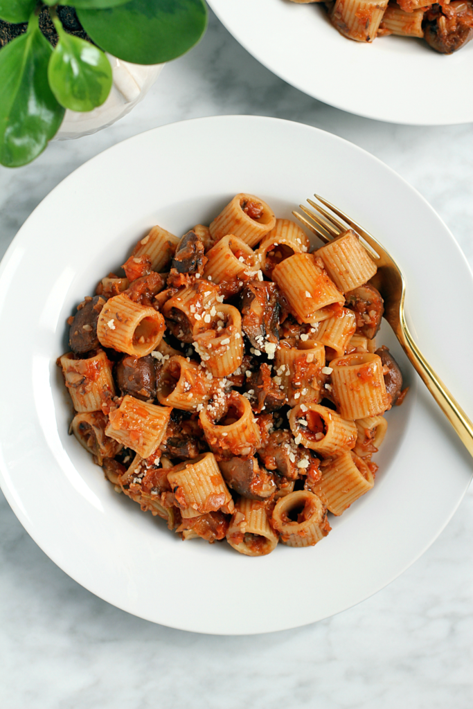 Close-up image of pasta with charred vegetable ragù.