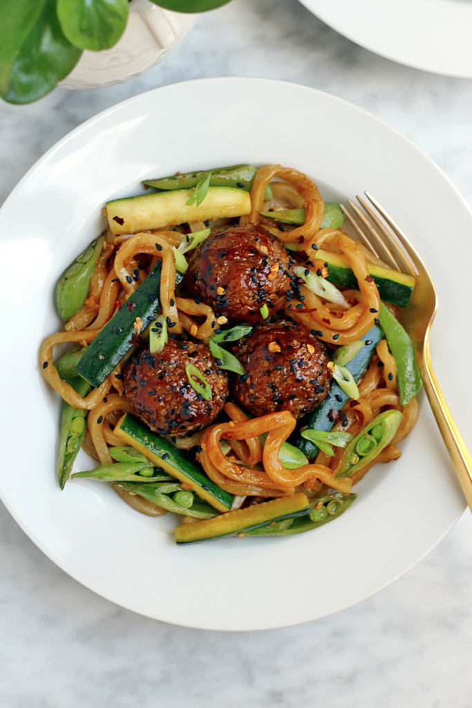 Close-up image of hoisin-turkey meatballs with udon noodles.