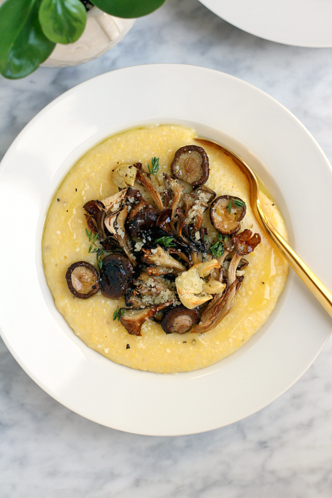 Close-up image of oven polenta with roasted mushrooms and thyme.