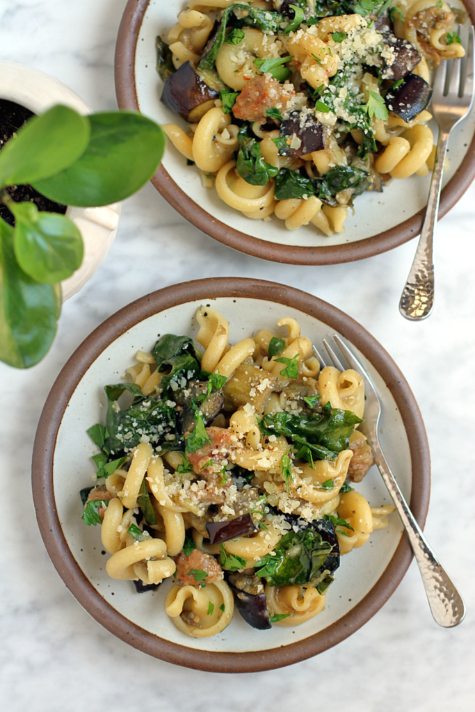 Image of pasta with eggplant, kale and sausage.