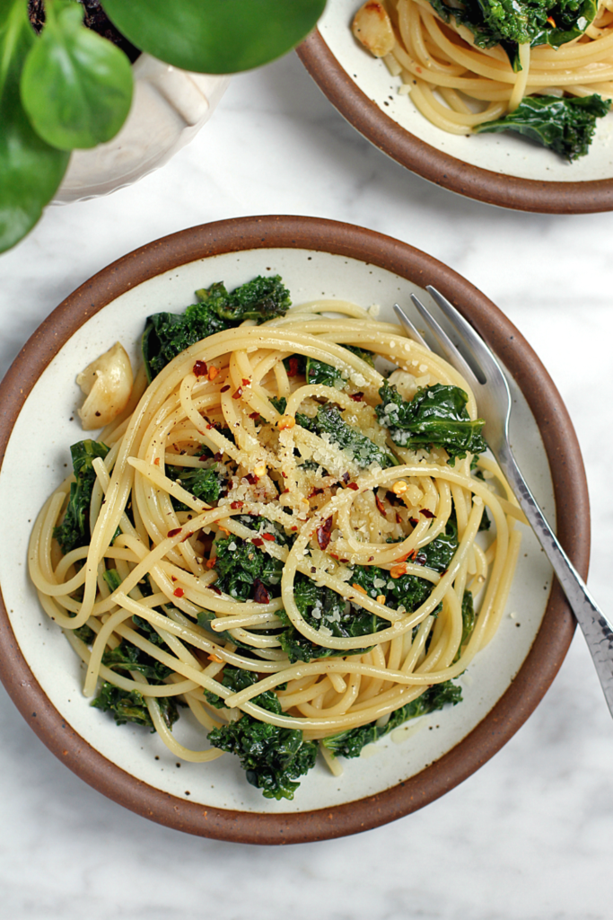 Close-up image of spaghetti aglio e olio with kale.