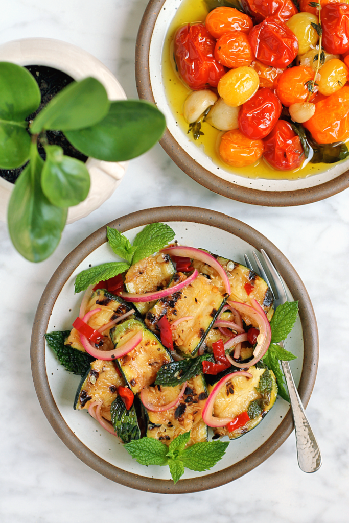 Image of torn zucchini with mint and Calabrian chiles.