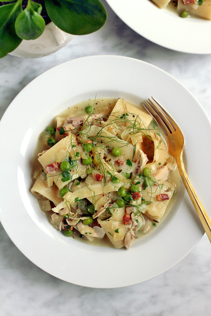 Close-up image of pasta with chicken ragù, fennel and peas.