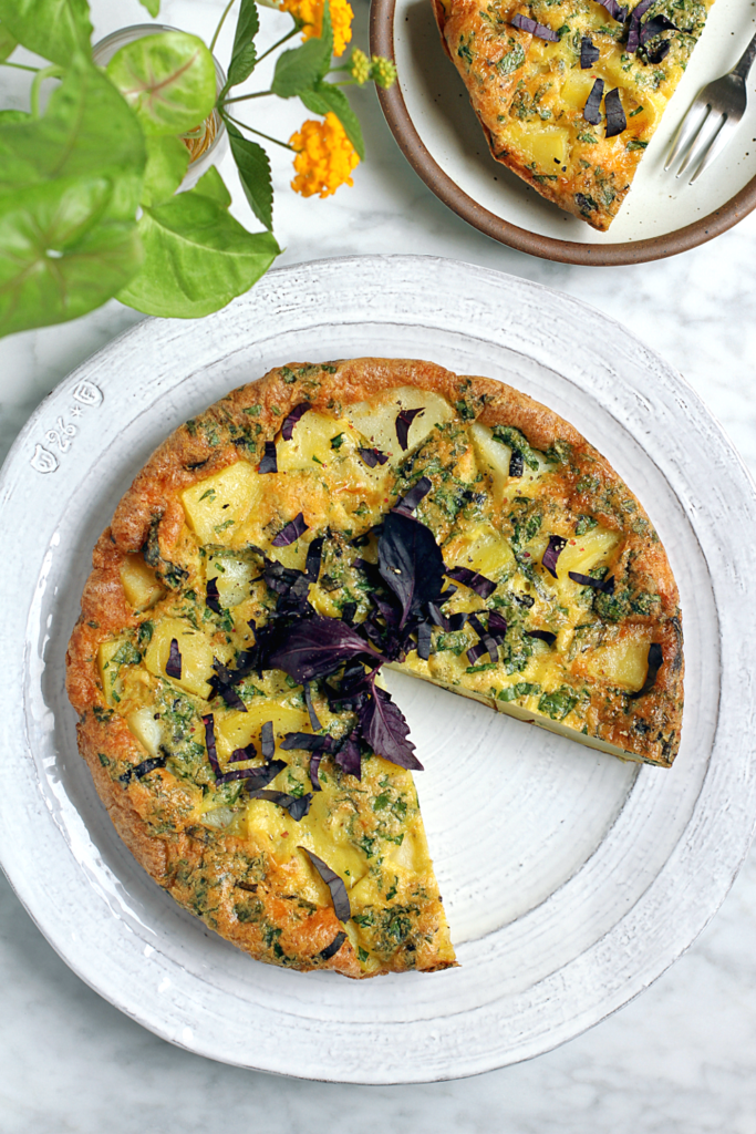 Image of potato frittata with cheese and herbs.