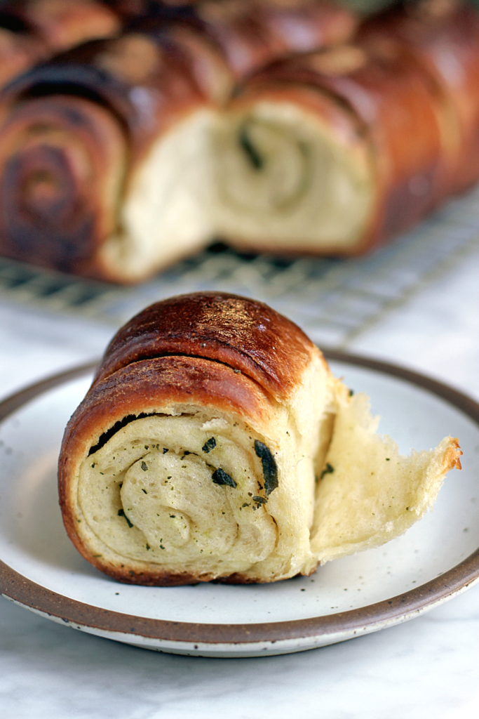 Image of a pull-apart brioche roll with sage butter.