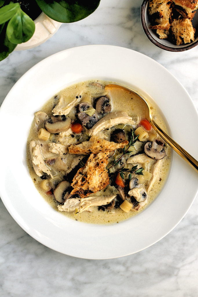 Close-up image of creamy chicken and mushroom soup.
