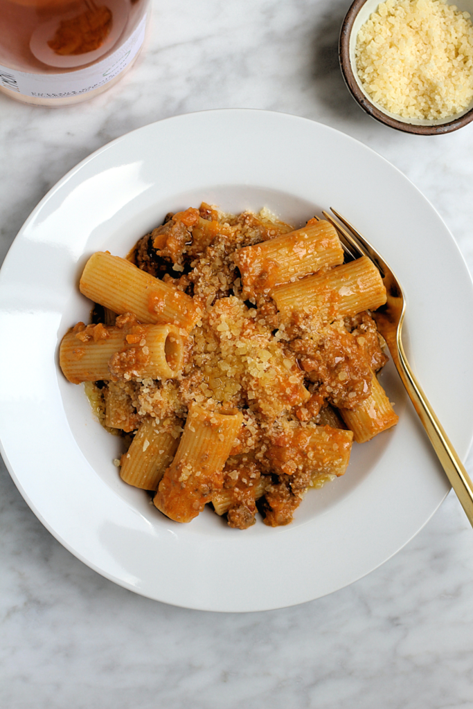 Close-up image of rigatoni with beef Bolognese.