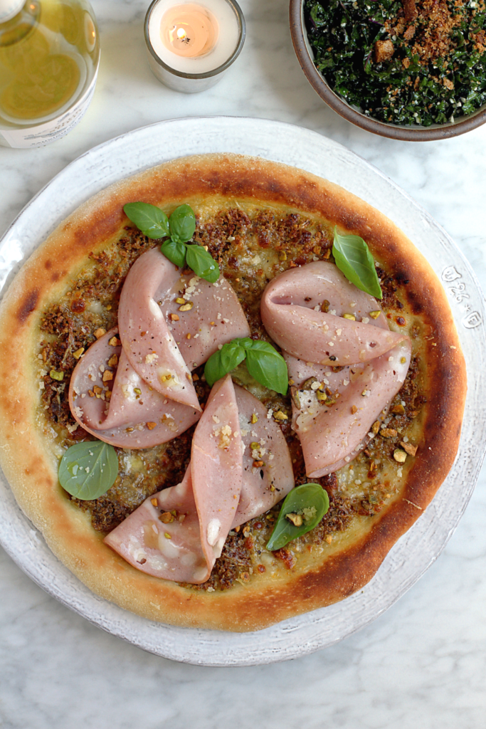 Image of mortadella and pistachio pizza.