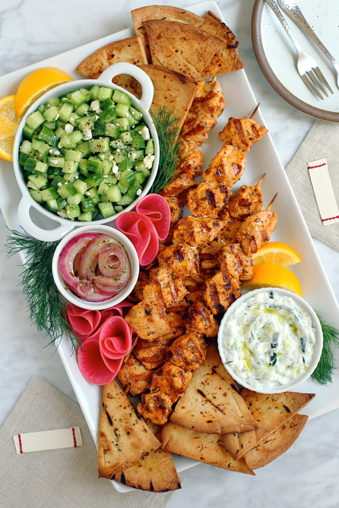 Image of chicken souvlaki with tzatziki.