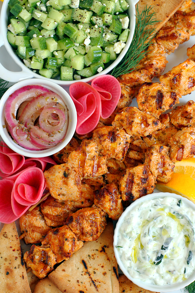 Close-up image of chicken souvlaki with tzatziki.