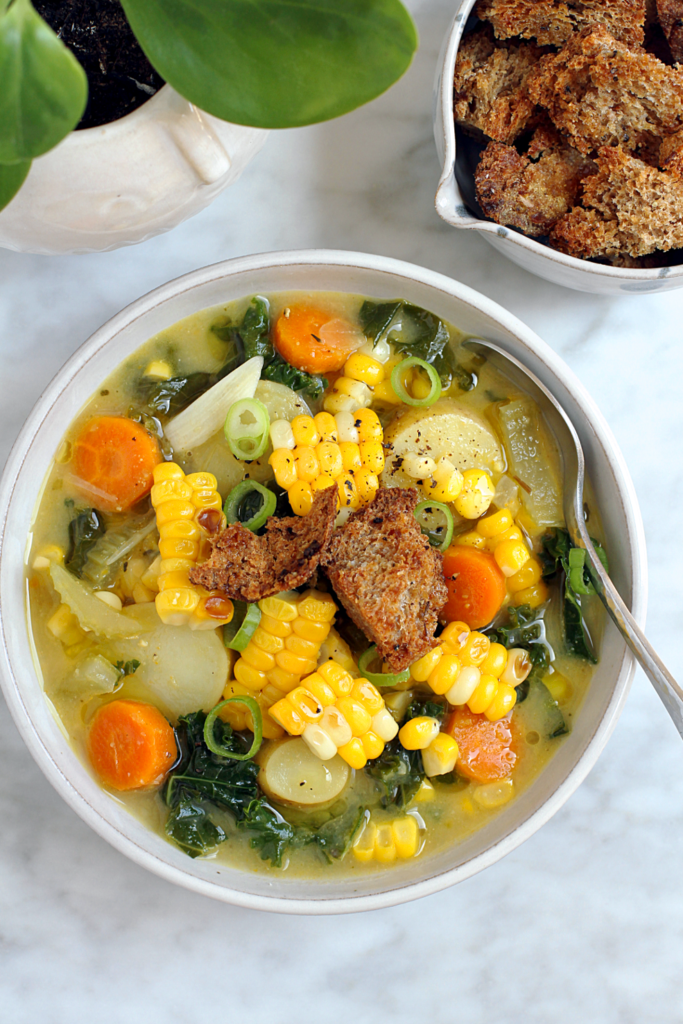 Close-up image of vegan corn and kale chowder.