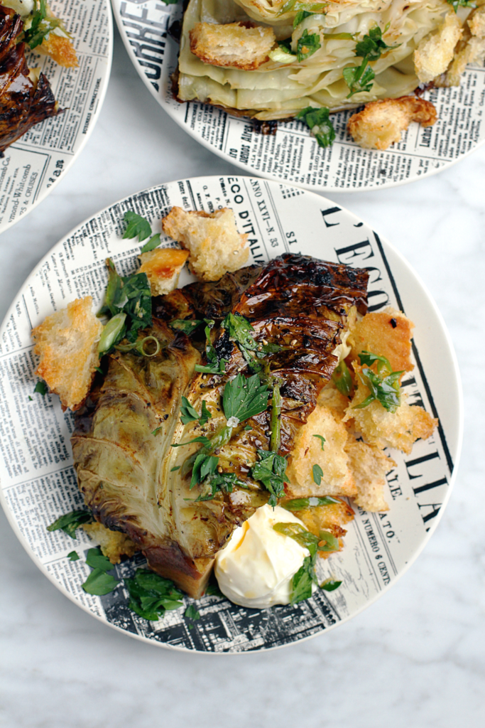 Close-up image of whole roasted cauliflower with whipped ricotta.