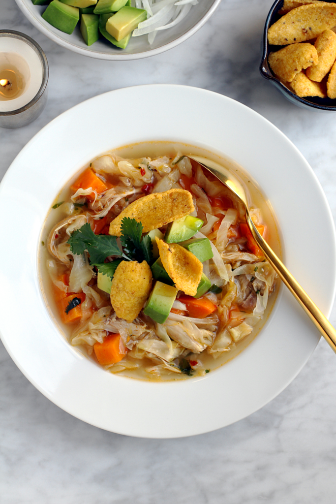 Close-up image of chicken soup with sweet potatoes and cabbage.