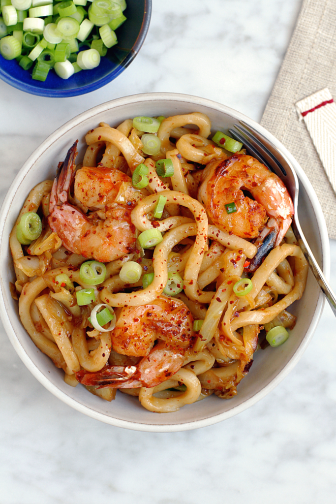 Close-up image of garlic shrimp udon noodles.