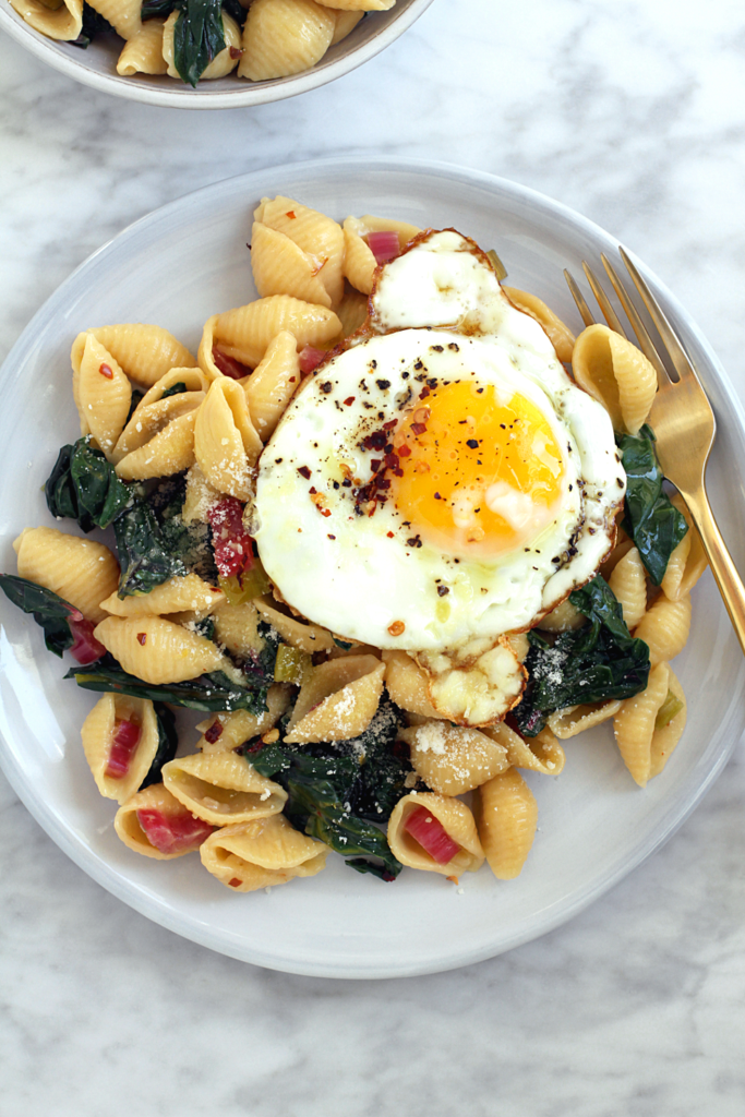 Close-up image of lemony pasta with rainbow chard and Parmesan cheese.