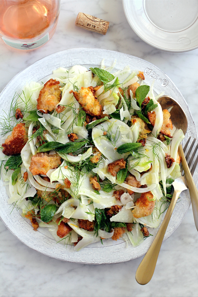 Image of shaved fennel salad with croutons and walnuts.