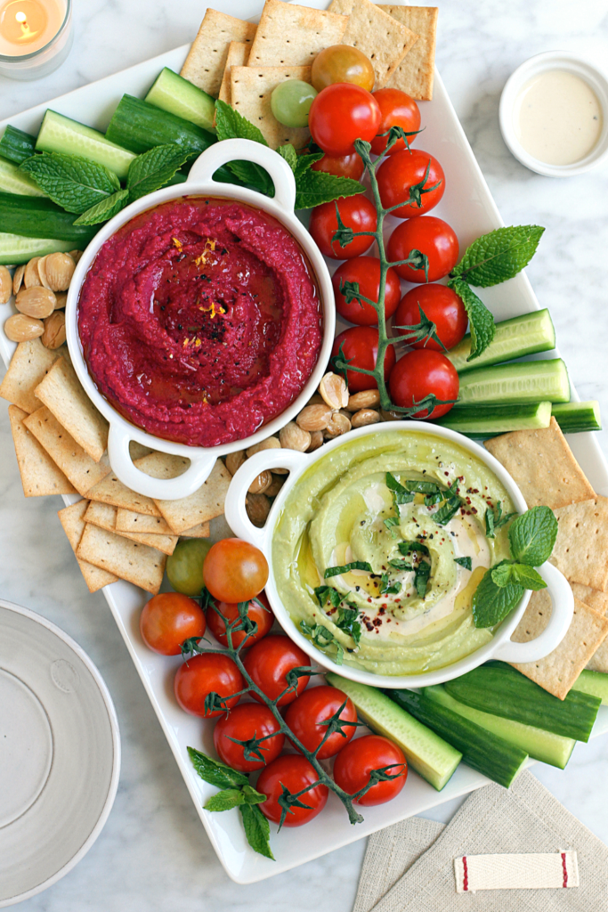 Image of beet hummus and creamy avocado hummus.