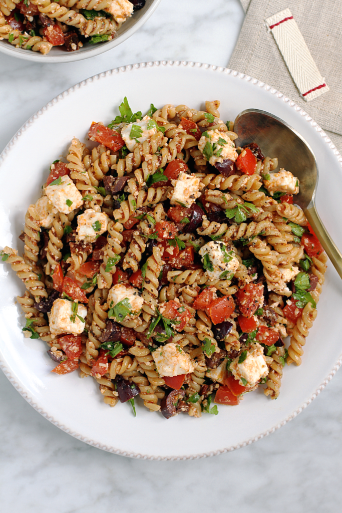 Close-up image of tomato and feta pasta salad.