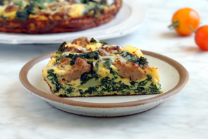 Image of a slice of kale and sausage frittata.