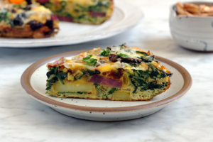 Image of a slice of rainbow chard and potato frittata.