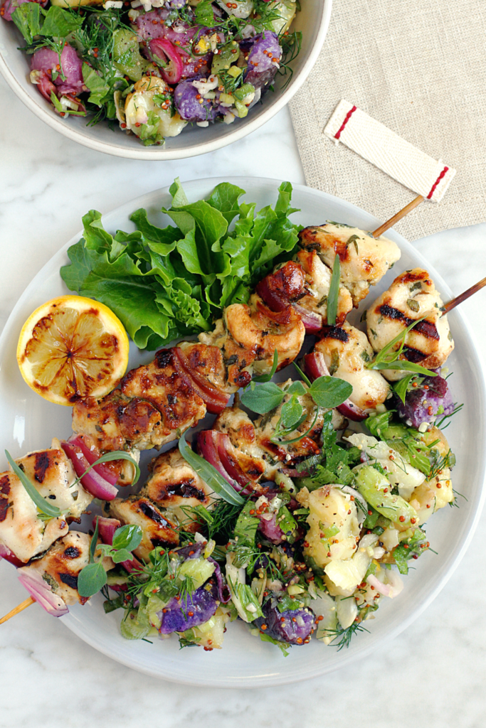 Close-up image of tangy potato salad with celery and mustard.