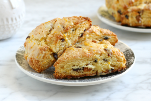 Close-up image of orange raisin scones.