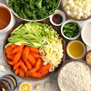 Image of ingredients for vegan winter greens stew with herb dumplings.