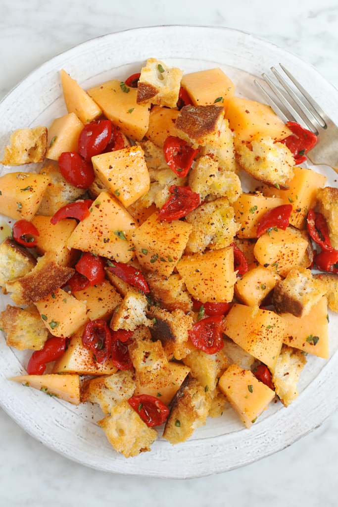 Close-up image of melon panzanella.